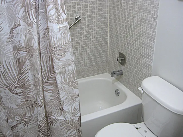 a white bath tub sitting next to a white toilet