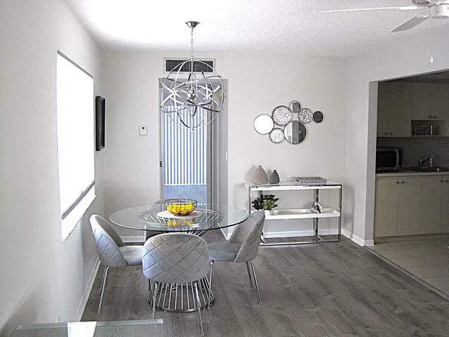 a dining room with furniture a rug and wooden floor