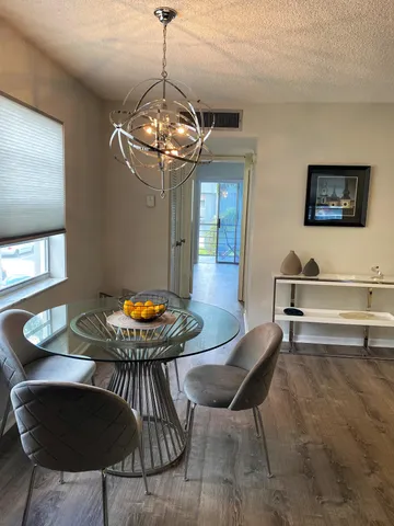 a view of a dining room with furniture wooden floor and chandelier