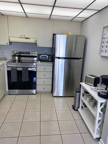 a kitchen with a stove top oven and cabinets