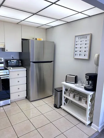 a kitchen with stainless steel appliances a refrigerator and a stove top oven