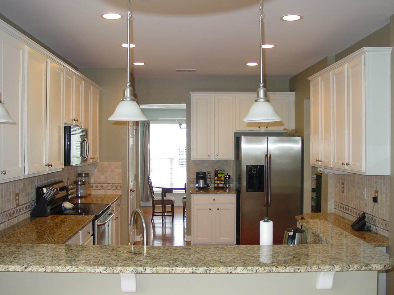 7724 Jackson Dane Drive Raleigh, NC 27613 - Photo 4 of 25 Granite, hardwoods, 42" cabinets, tile backsplash, built in desk, pantry, breakfast bar and stainless appliances. Kitchen