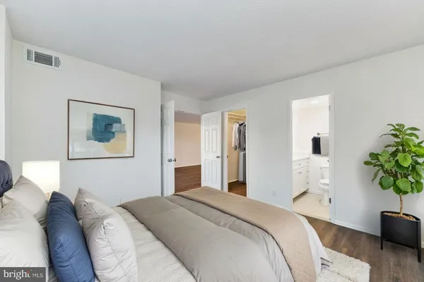 a bedroom with a bed and a couch