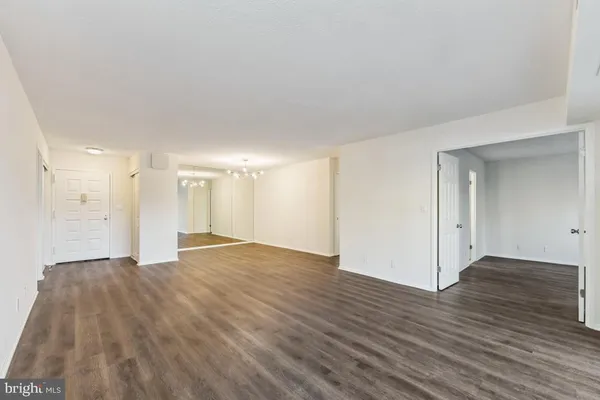 a view of an empty room and wooden floor