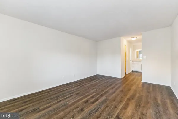 a view of an empty room and wooden floor