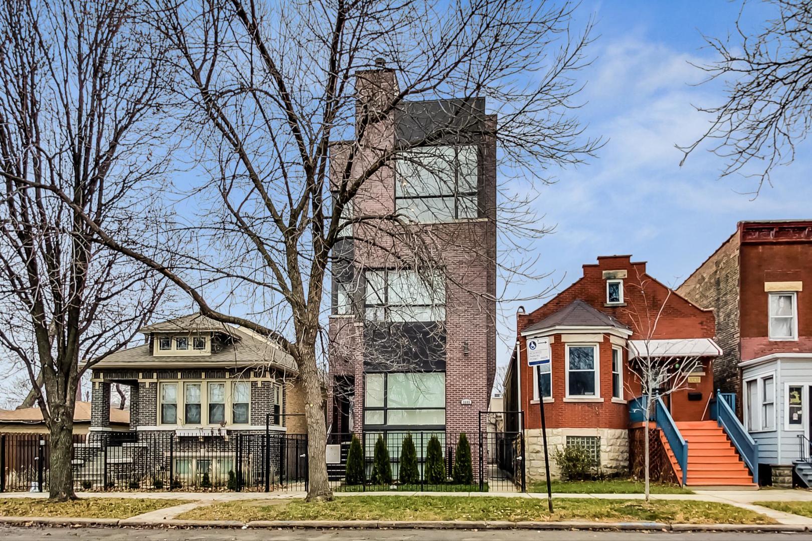 a front view of a residential apartment building with a yard