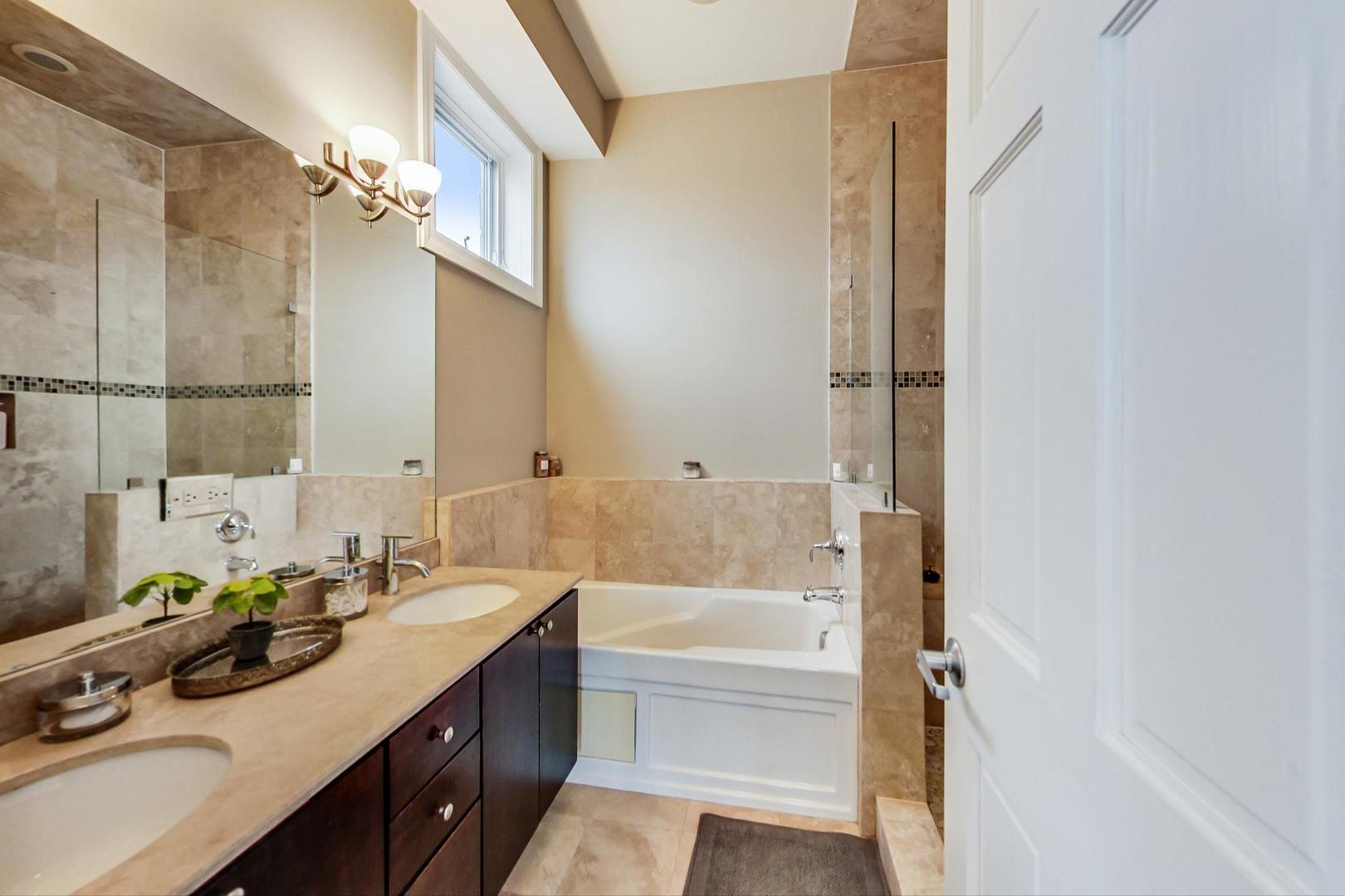 3605 South Leavitt Street, Unit 3 Chicago, IL 60609 - Photo 13 of 22 a bathroom with a tub sink and mirror