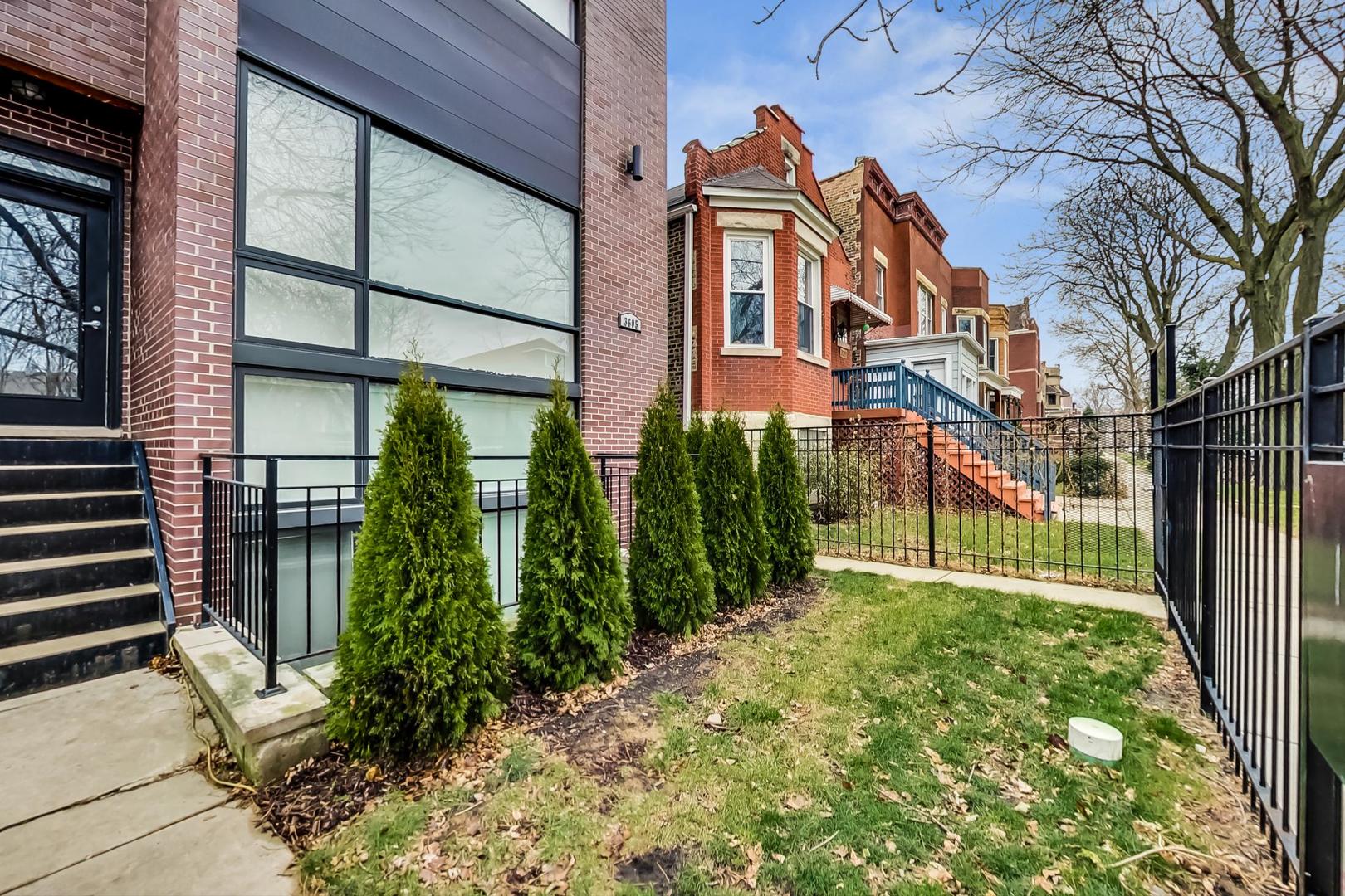 3605 South Leavitt Street, Unit 3 Chicago, IL 60609 - Photo 2 of 22 a view of a yard with plants and brick wall of a building