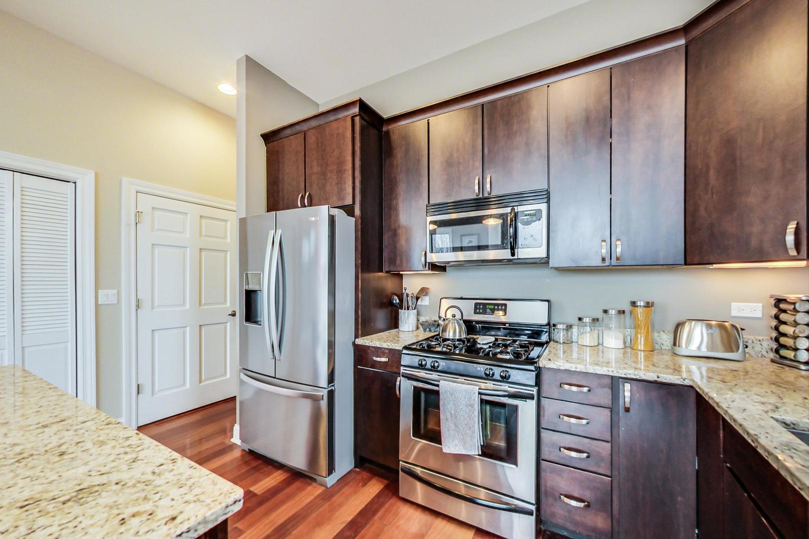 3605 South Leavitt Street, Unit 3 Chicago, IL 60609 - Photo 9 of 22 a kitchen with stainless steel appliances granite countertop a refrigerator stove and sink