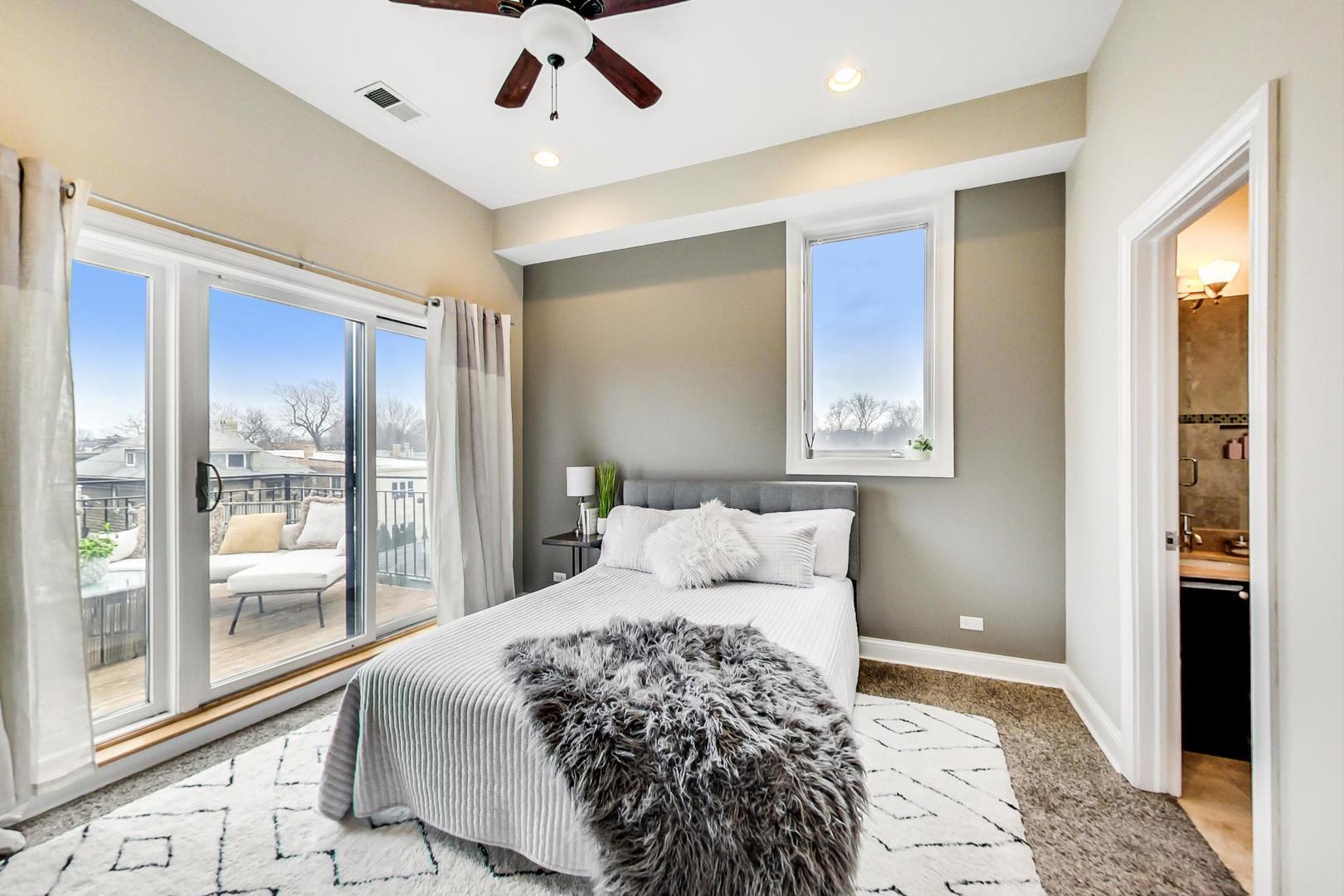 3605 South Leavitt Street, Unit 3 Chicago, IL 60609 - Photo 10 of 22 a bedroom with a large bed and a large window