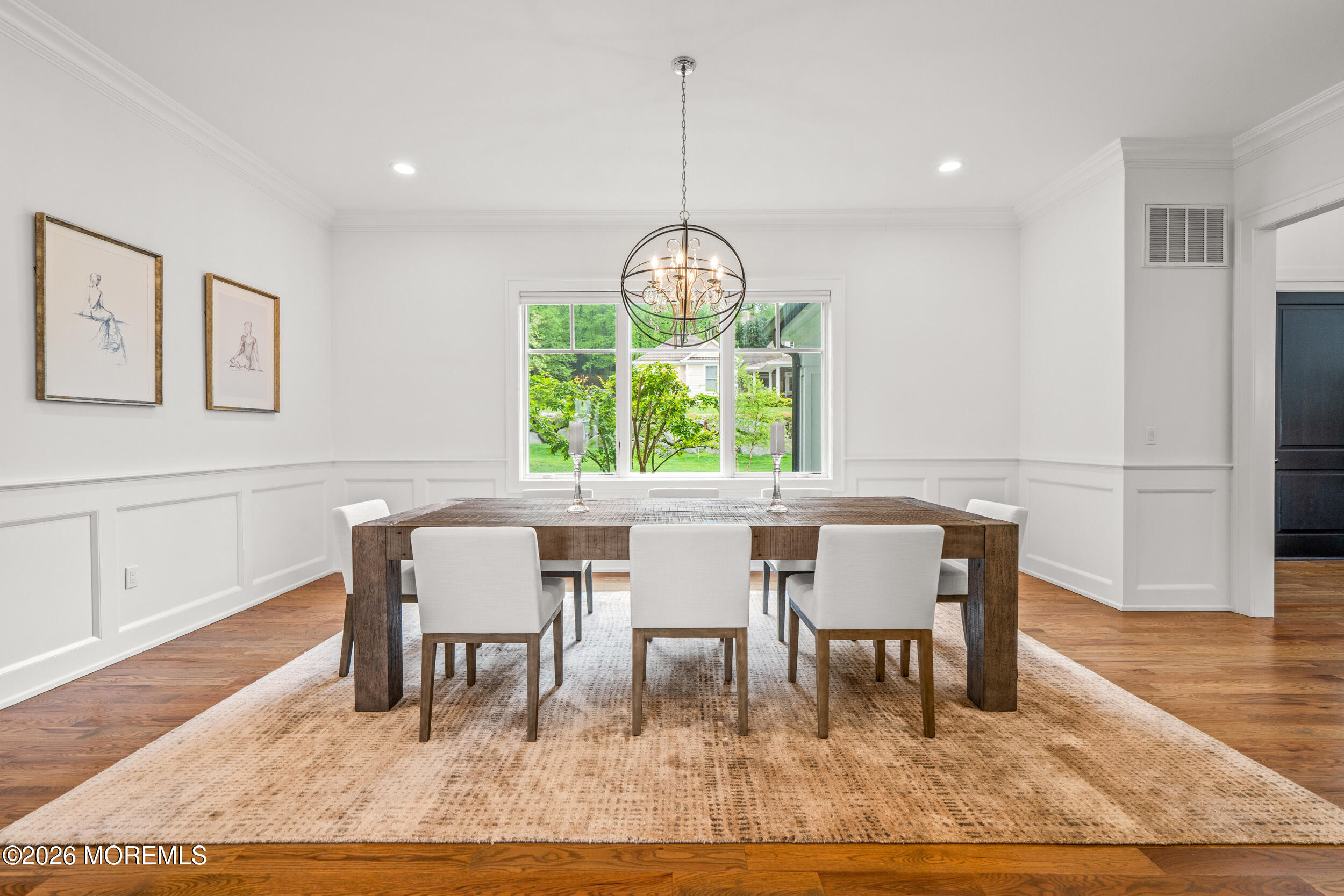 11 Beacon Hill Road Atlantic Highlands, NJ 07716 - Photo 21 of 74 a dining room with wooden floor and a chandelier