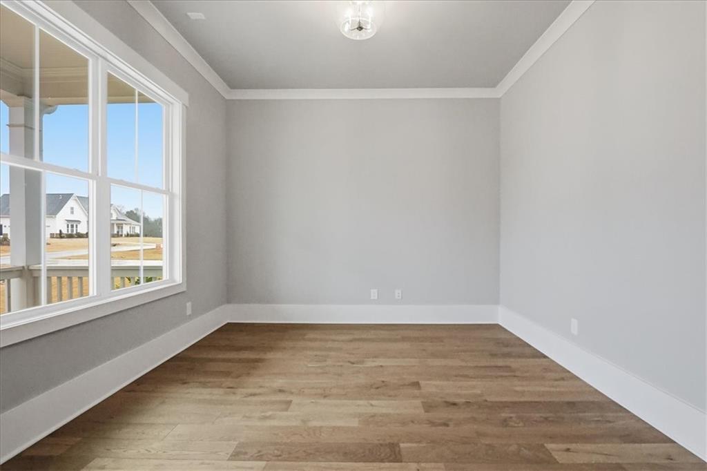 216 Ewing Way Dacula, GA 30019 - Photo 21 of 80 wooden floor in an empty room with a window
