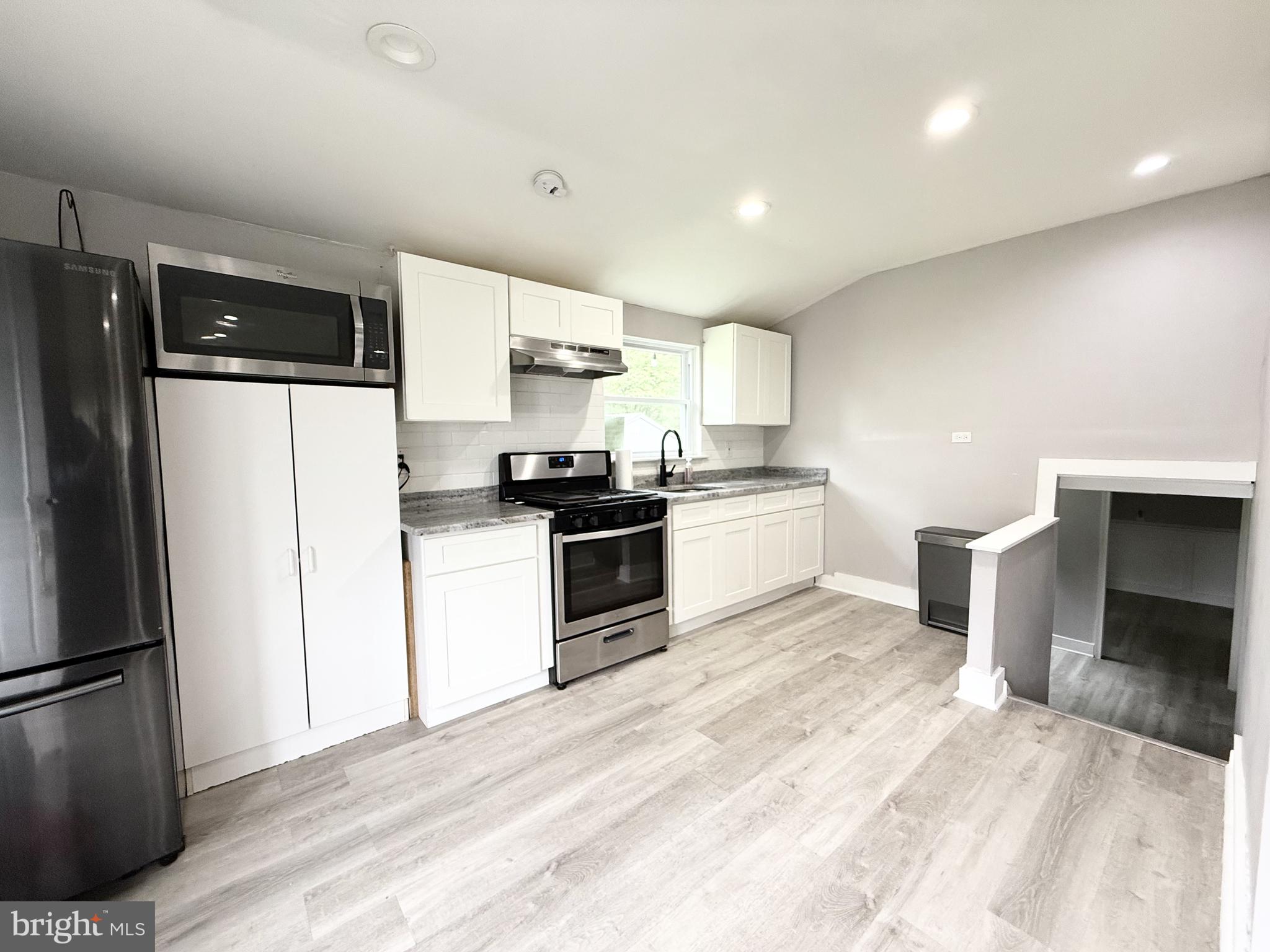 20 Chestnut Drive Elkton, MD 21921 - Photo 10 of 68 a kitchen with a refrigerator a stove top oven and white cabinets