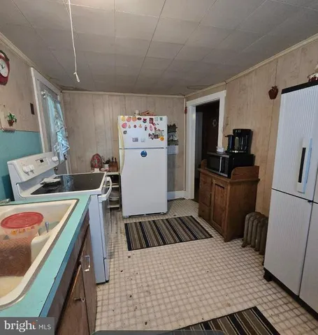 a kitchen with a sink stove and refrigerator