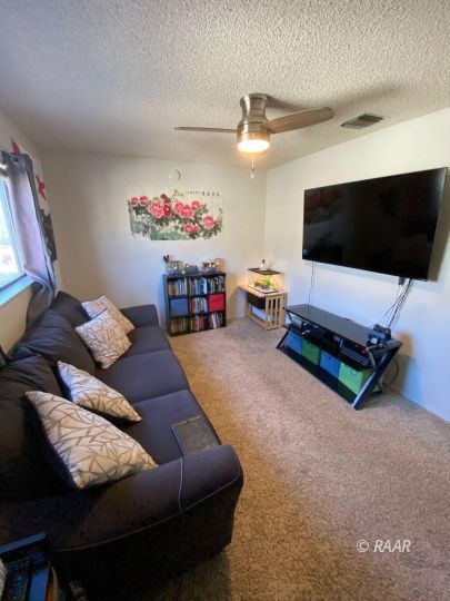 277 East Upjohn Avenue Ridgecrest, CA 93555 - Photo 14 of 20 a living room with furniture and a flat screen tv