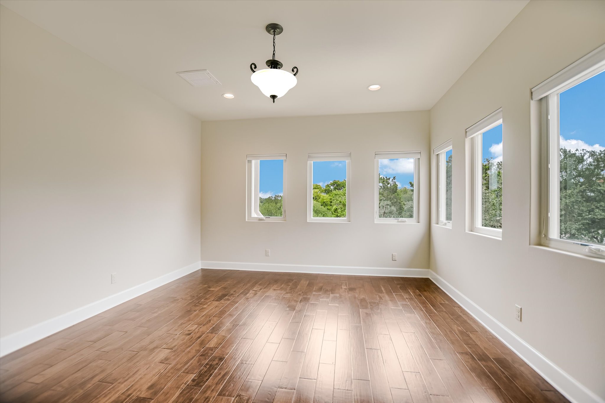 11 Inwood Circle Austin, TX 78746 - Photo 23 of 38 Ample natural light illuminates rich hardwood floors in this versatile living space.