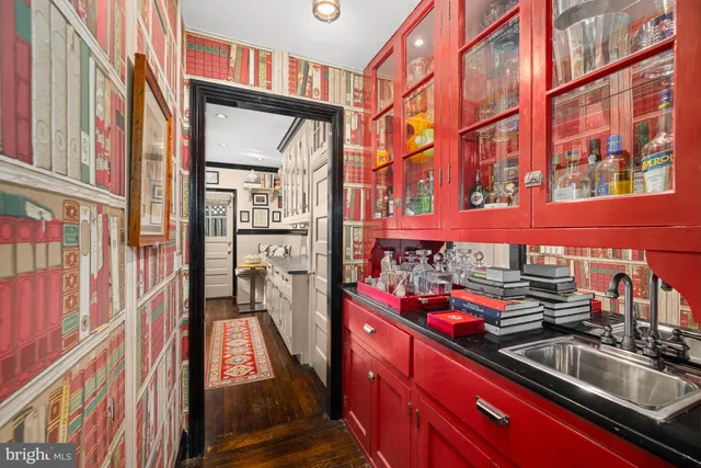 a kitchen filled with a refrigerator a sink and a cabinets