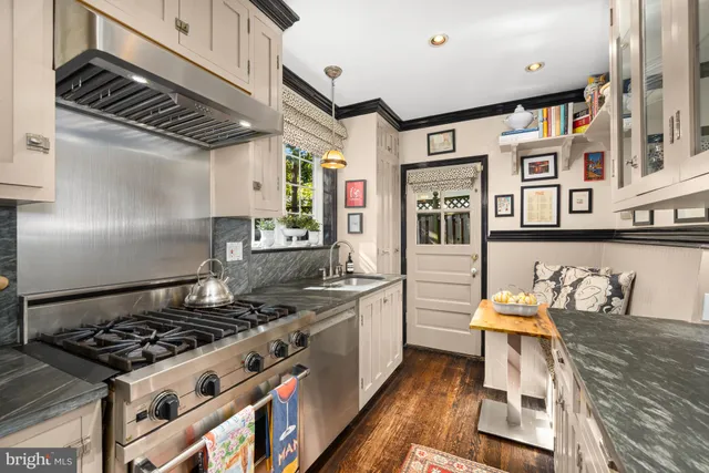 a kitchen with stainless steel appliances granite countertop a stove and a sink