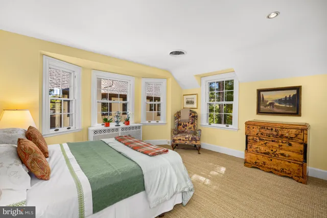 a living room with furniture and a book shelf