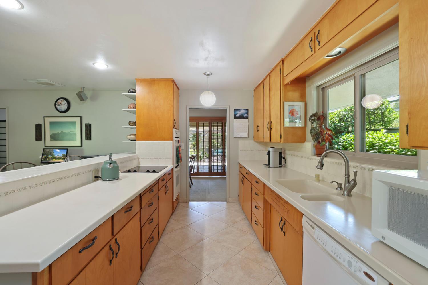 2406 Kenmore Court Modesto, CA 95350 - Photo 21 of 54 a large white kitchen with a large window and stainless steel appliances