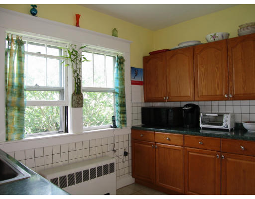 48 David Street Springfield, MA 01104 - Photo 5 of 21 a kitchen with stainless steel appliances wooden cabinets a stove a sink and a window