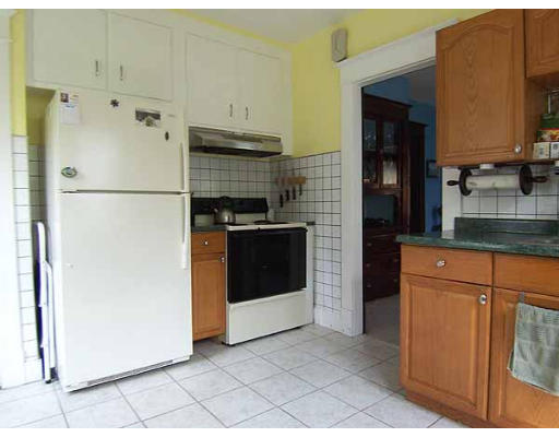 48 David Street Springfield, MA 01104 - Photo 6 of 21 a white refrigerator freezer and a stove sitting inside of a kitchen
