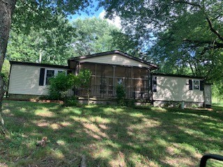 575 Templow Road Bethpage, TN 37022 - Photo 1 of 15 a view of a wooden house with a yard