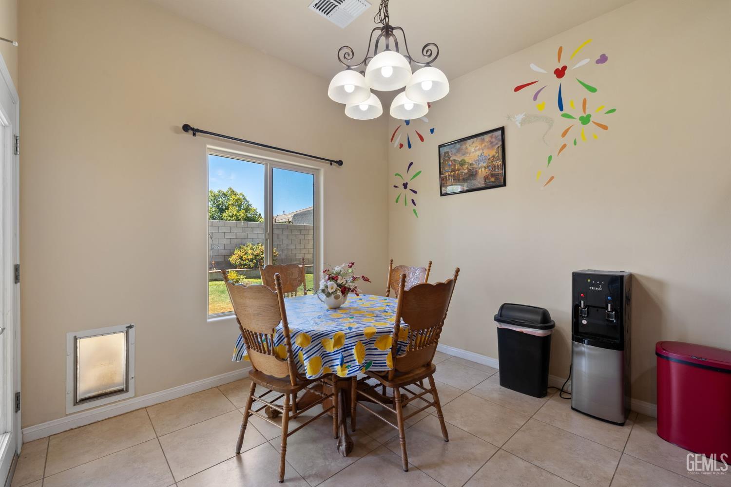 Undisclosed Address Bakersfield, CA 93314 - Photo 11 of 45 a view of a dining room with furniture and chandelier