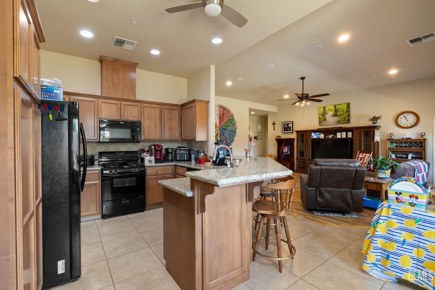 Undisclosed Address Bakersfield, CA 93314 - Photo 13 of 45 a kitchen that has a lot of cabinets and refrigerator in it