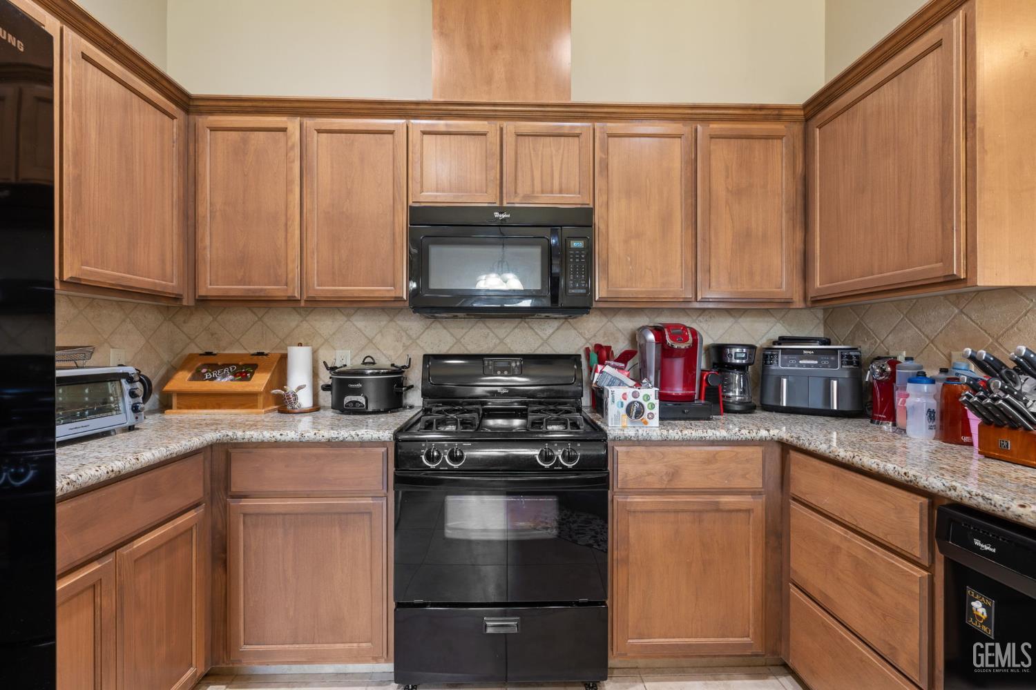 Undisclosed Address Bakersfield, CA 93314 - Photo 16 of 45 a kitchen with granite countertop cabinets stainless steel appliances and a sink
