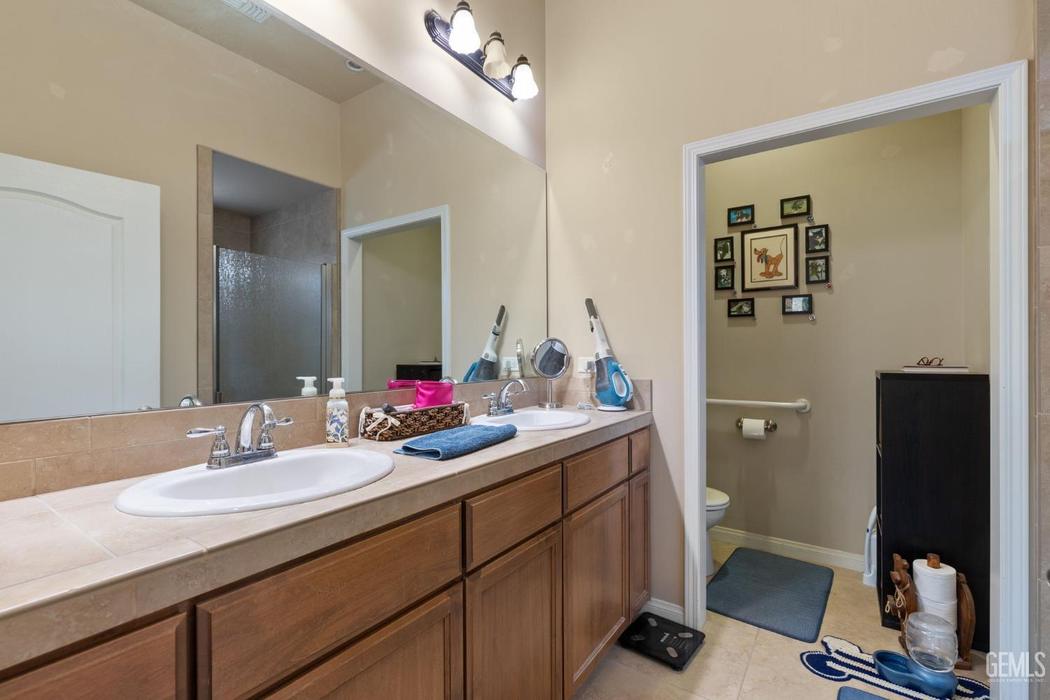 Undisclosed Address Bakersfield, CA 93314 - Photo 22 of 45 a bathroom with a sink and a mirror