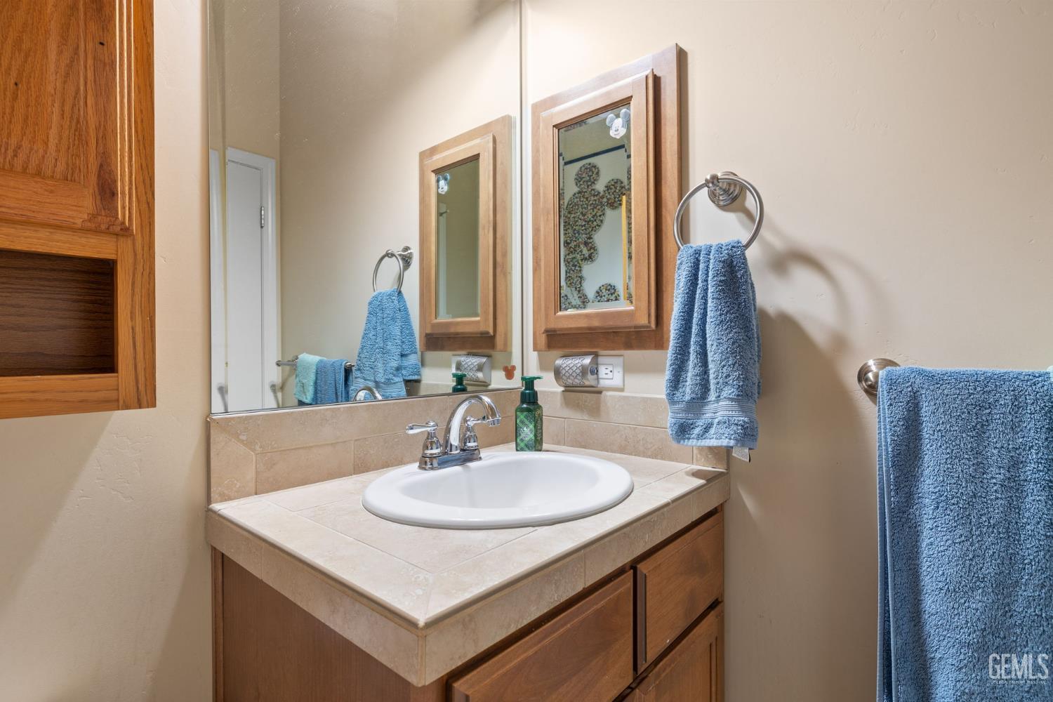 Undisclosed Address Bakersfield, CA 93314 - Photo 28 of 45 a bathroom with a sink and a mirror