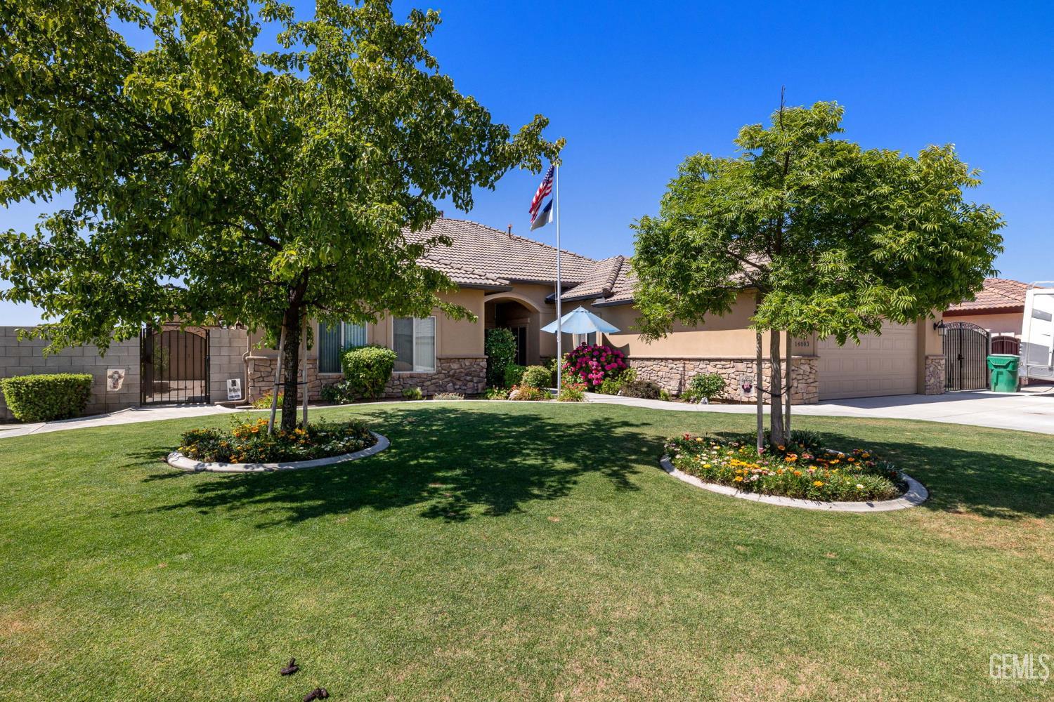 Undisclosed Address Bakersfield, CA 93314 - Photo 3 of 45 a front view of a house with garden