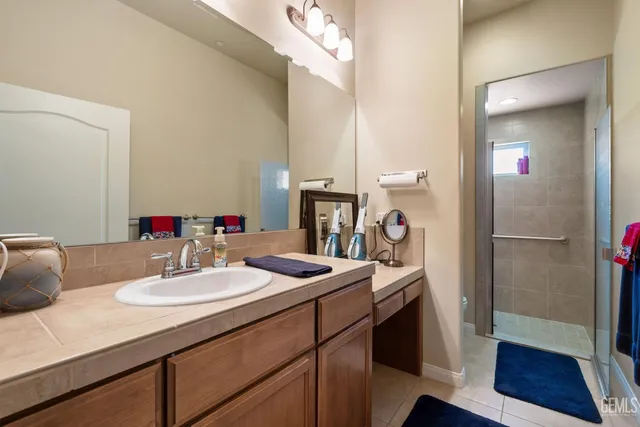 a bathroom with a toilet sink vanity and mirror