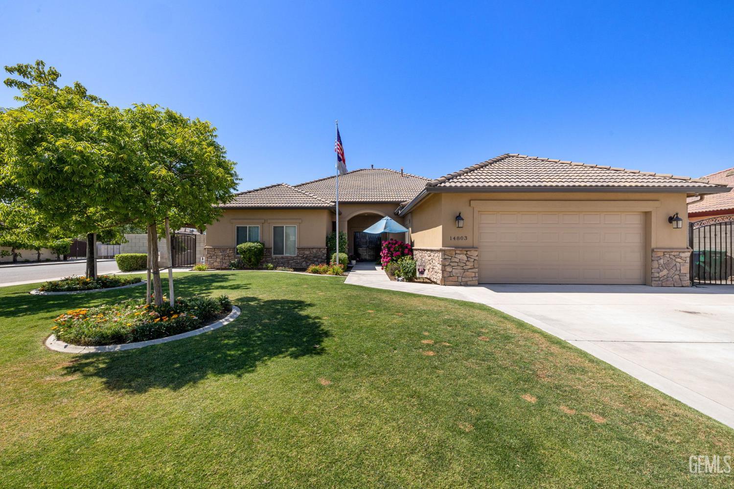 Undisclosed Address Bakersfield, CA 93314 - Photo 4 of 45 a front view of a house with a garden