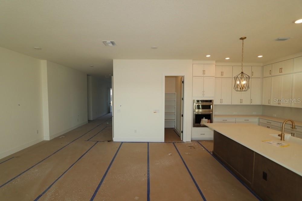 17547 Foxtail Loop Venice, FL 34293 - Photo 3 of 11 a kitchen with a sink and refrigerator