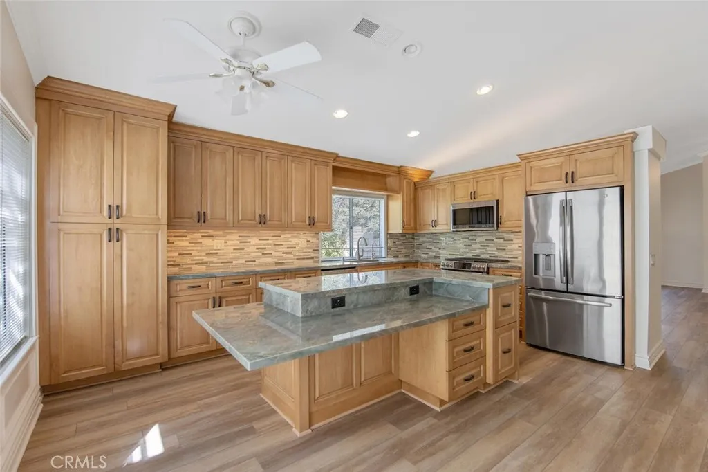 27619 Ron Ridge Drive Saugus, CA 91350 - Photo 11 of 37 a kitchen with a stove a refrigerator and a sink