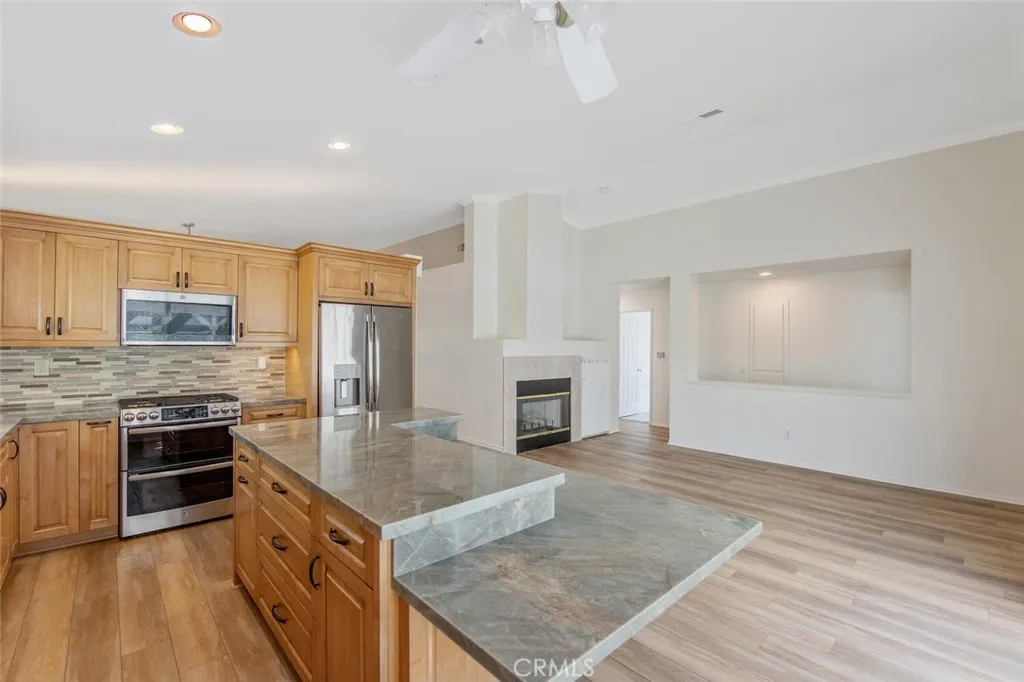 27619 Ron Ridge Drive Saugus, CA 91350 - Photo 16 of 37 a kitchen with stainless steel appliances granite countertop a stove top oven a sink and dishwasher