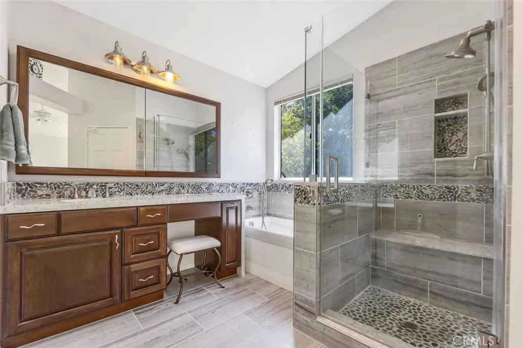 27619 Ron Ridge Drive Saugus, CA 91350 - Photo 19 of 37 a bathroom with a sink a mirror and a shower