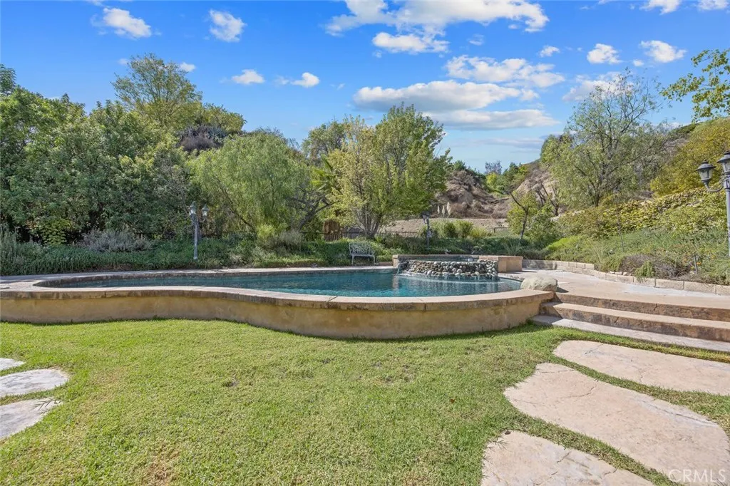 27619 Ron Ridge Drive Saugus, CA 91350 - Photo 25 of 37 a view of a swimming pool with a yard