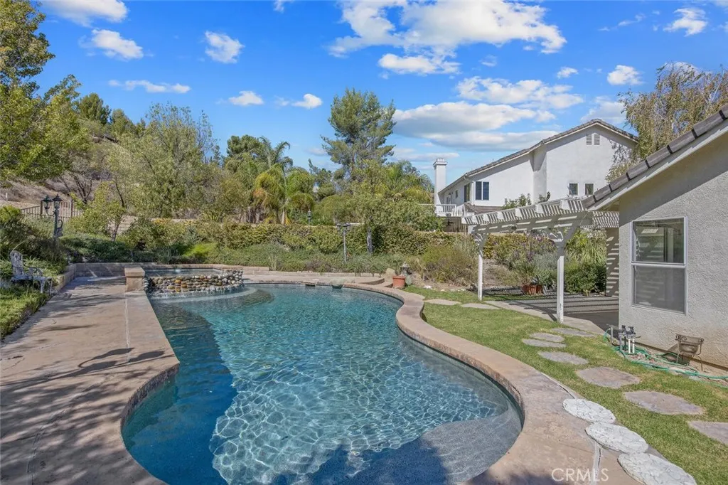 27619 Ron Ridge Drive Saugus, CA 91350 - Photo 30 of 37 a view of a backyard with couches plants and large trees