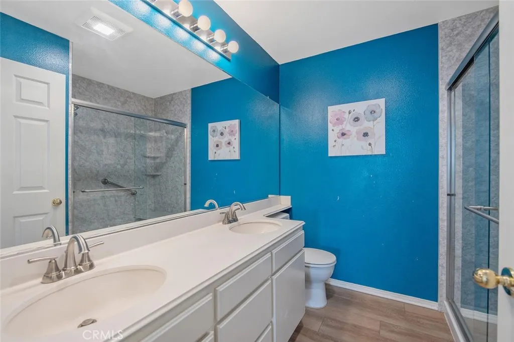 27619 Ron Ridge Drive Saugus, CA 91350 - Photo 35 of 37 a bathroom with a sink mirror vanity and toilet