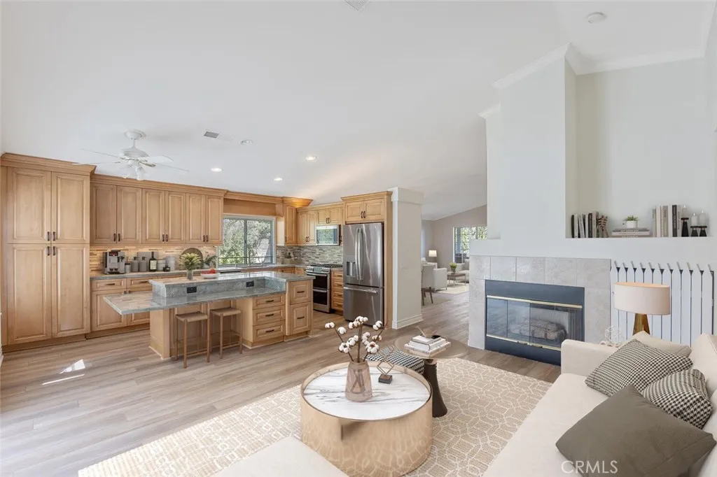 27619 Ron Ridge Drive Saugus, CA 91350 - Photo 5 of 37 a living room with stainless steel appliances furniture a fireplace and a kitchen view