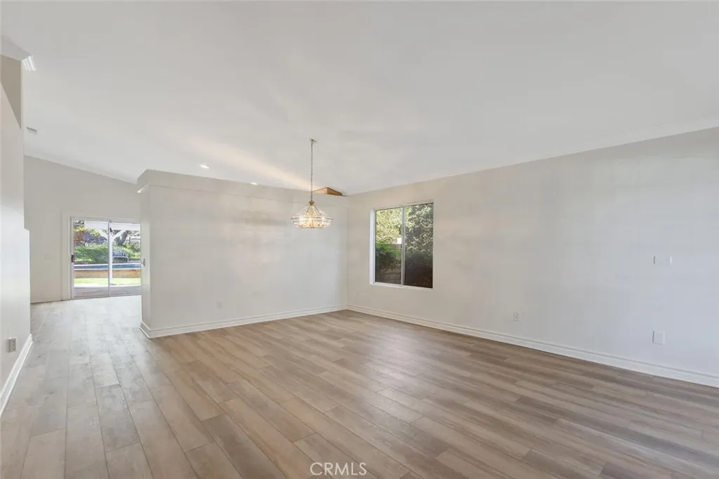 27619 Ron Ridge Drive Saugus, CA 91350 - Photo 6 of 37 an empty room with wooden floor and windows