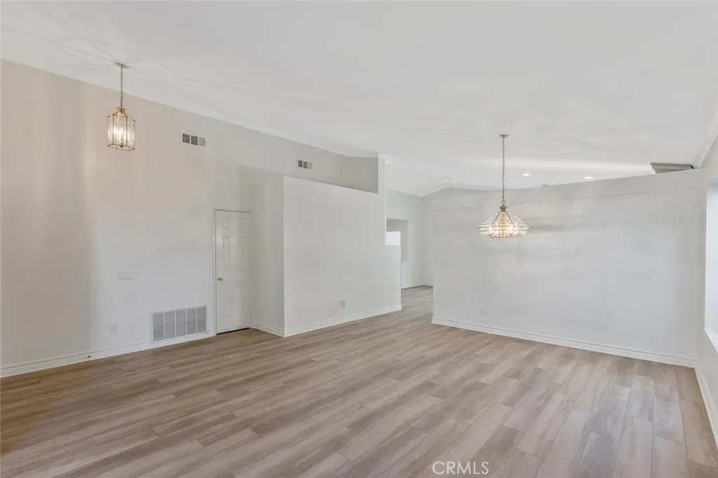 27619 Ron Ridge Drive Saugus, CA 91350 - Photo 7 of 37 an empty room with wooden floor and windows