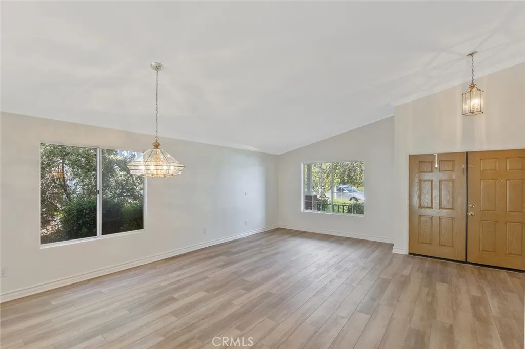 27619 Ron Ridge Drive Saugus, CA 91350 - Photo 9 of 37 a view of an empty room with wooden floor and a window
