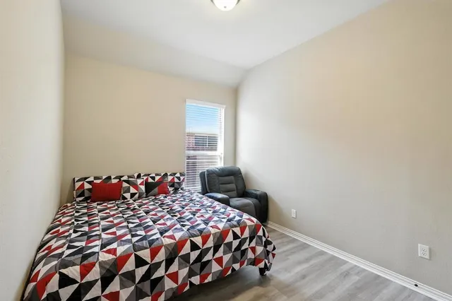 a bedroom with furniture and a window