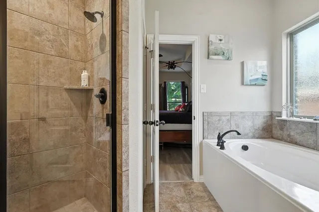 a bath tub sitting next to a bathroom sink