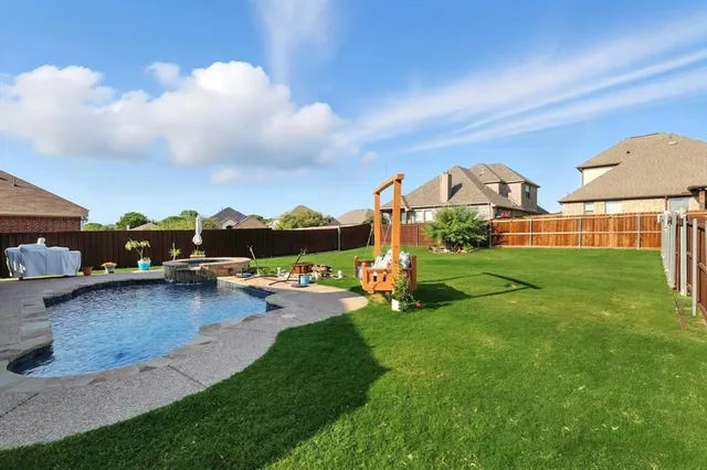 a view of an house with backyard space and garden