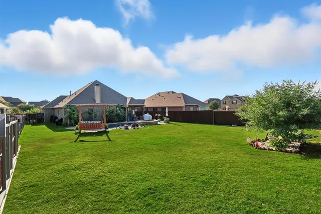 a view of a house with backyard and sitting area